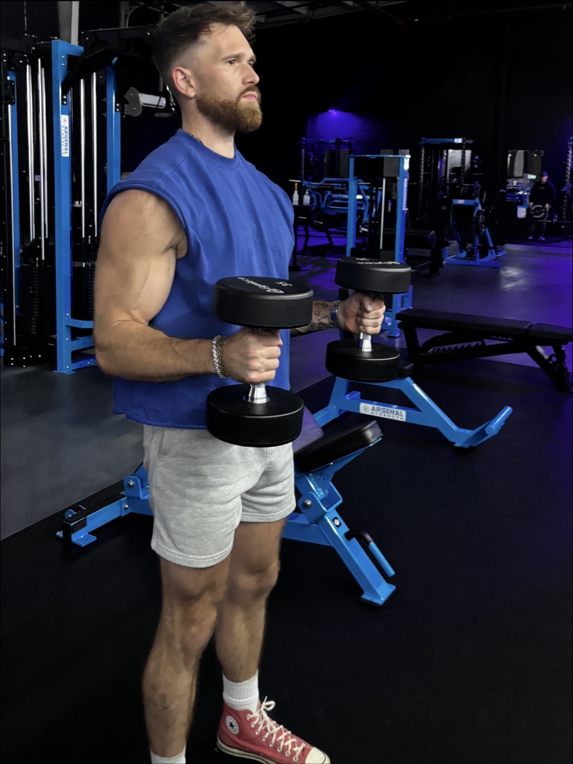 Casey Starchak training with dumbbells in a gym